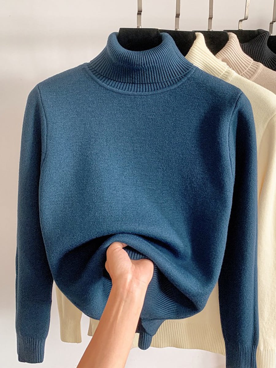 Blue sweater with the hem turned up to show the fleece