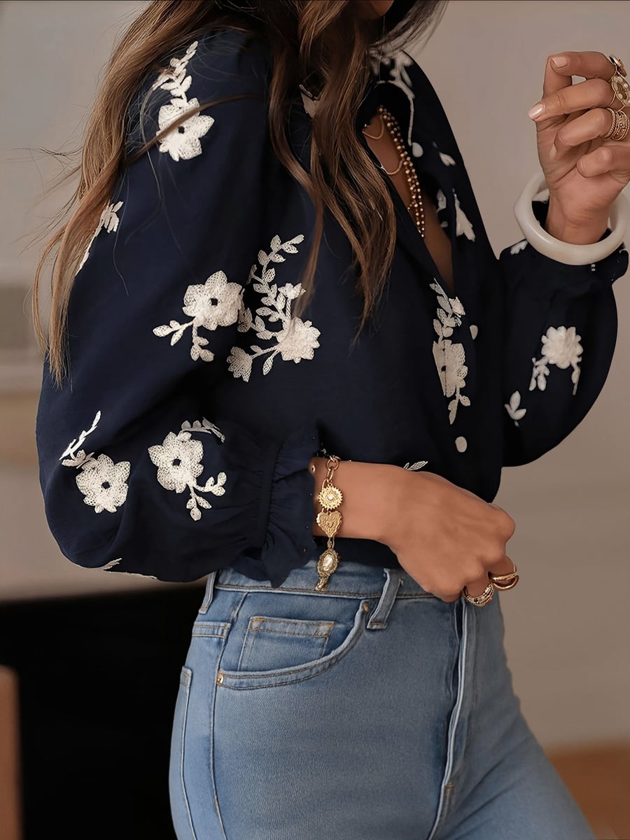 Side view showing the sleeve embroidery and ruffled cuff