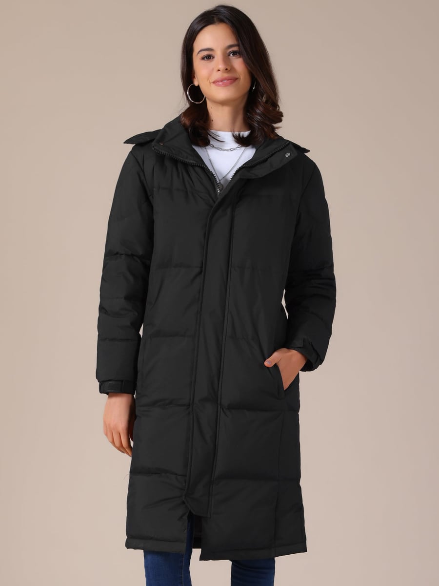 Front view, black puffer closed with a hand in the pocket
