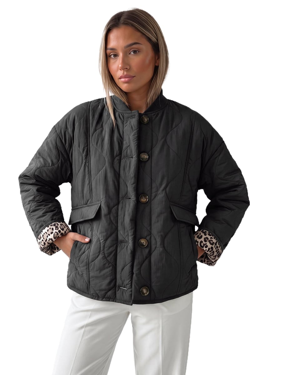 Front view, black jacket with hands in the pockets