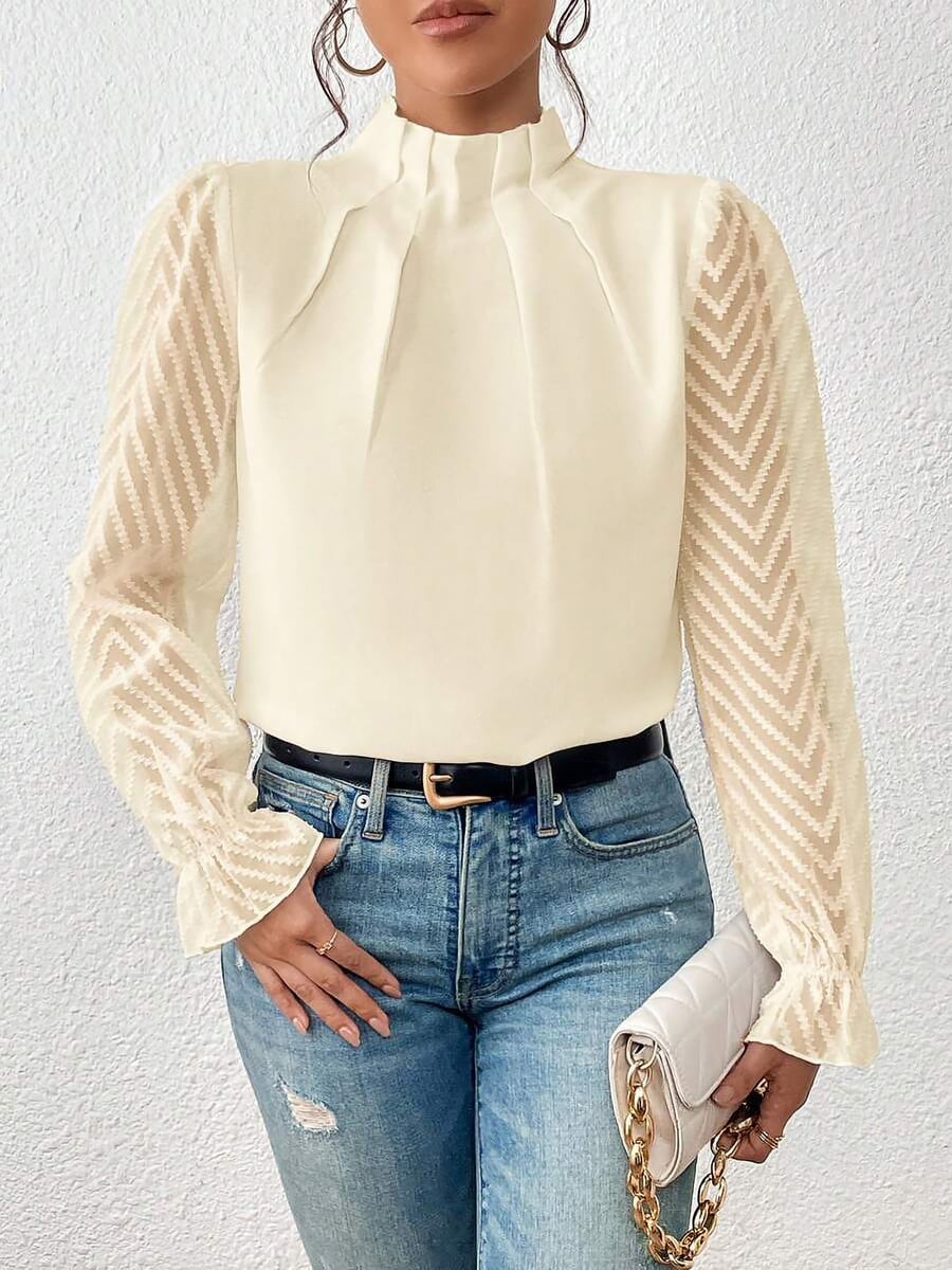Front view, cream blouse tucked into jeans