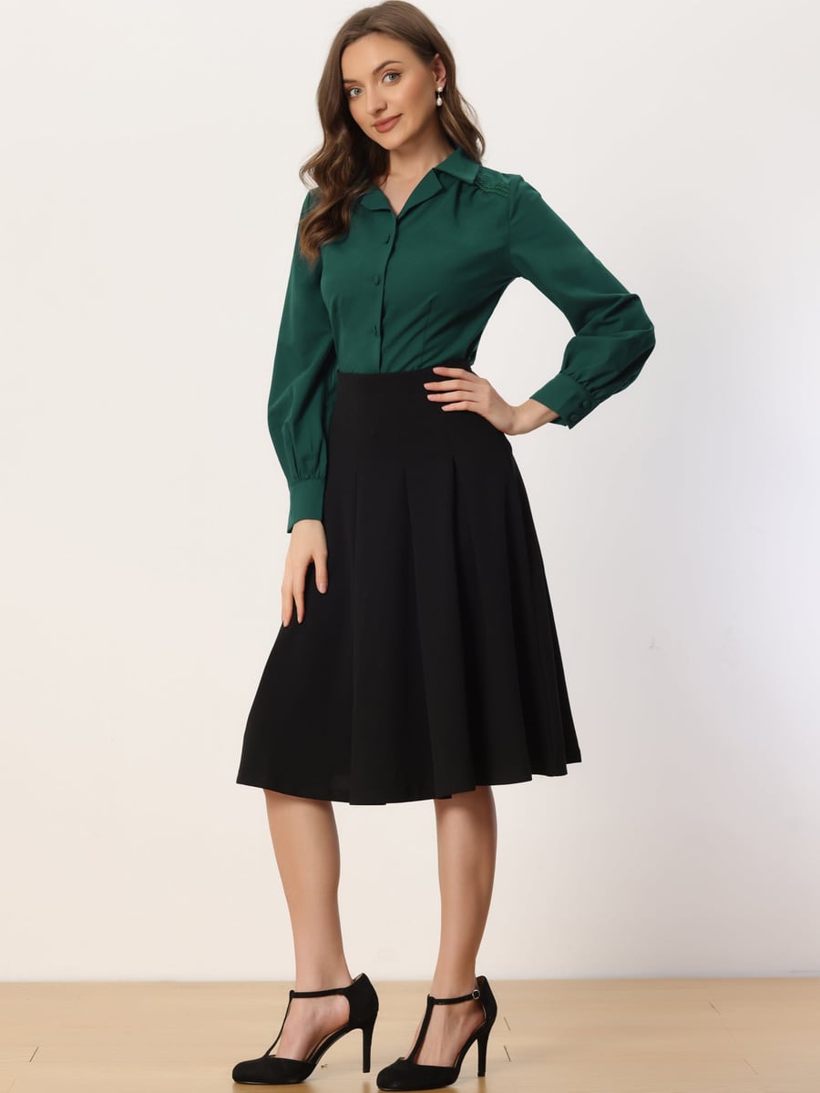 Wearing the dark green blouse