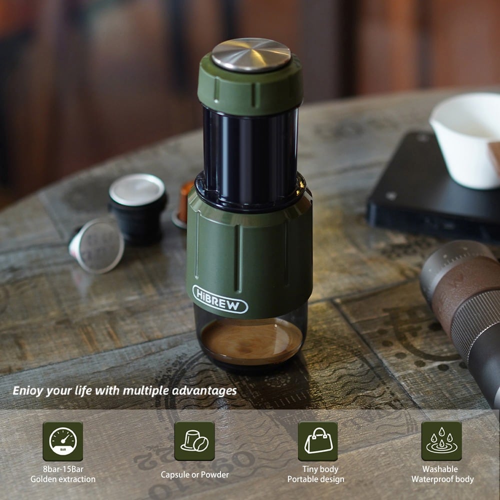On a wooden table beside capsules and a grinder