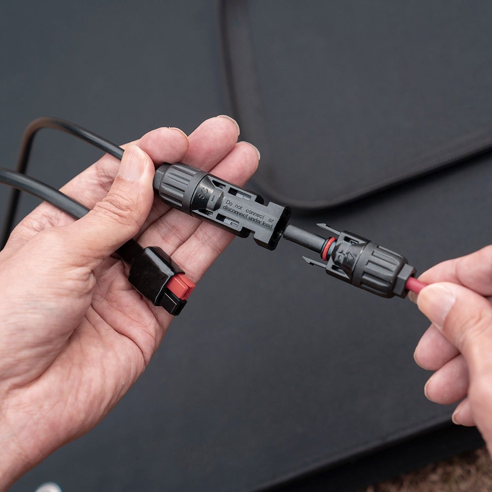 Hands joining the MC4 connectors