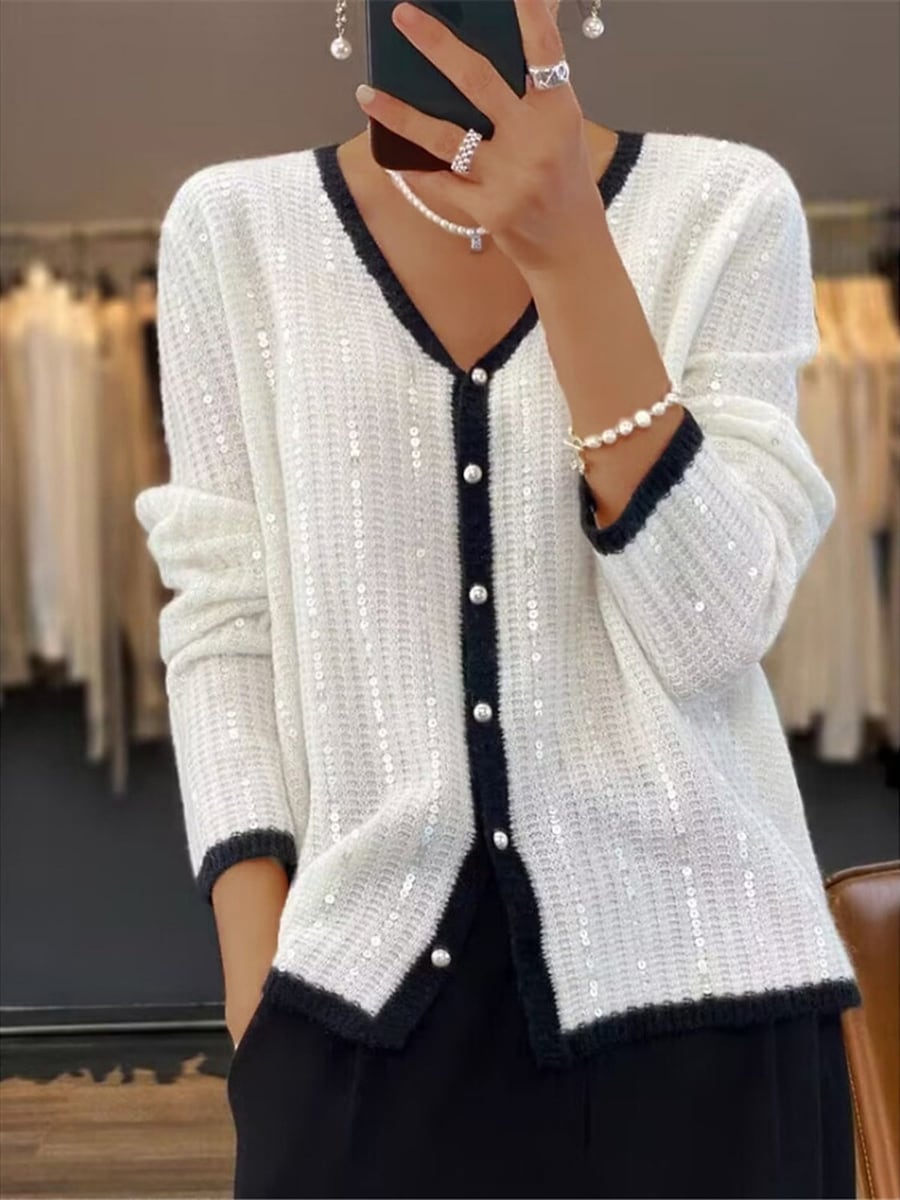 The white cardigan with black trim