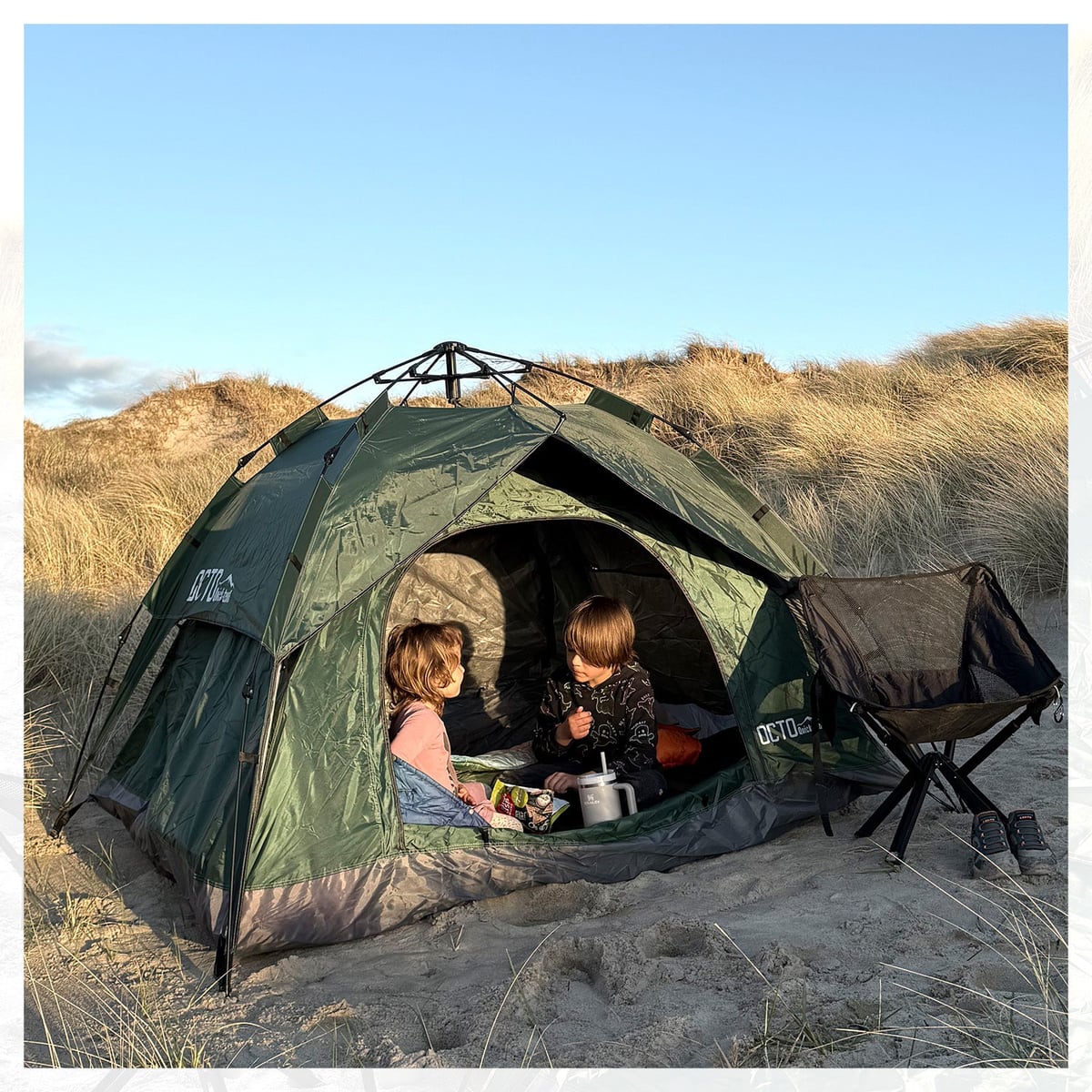 Pitched on dunes, kids inside