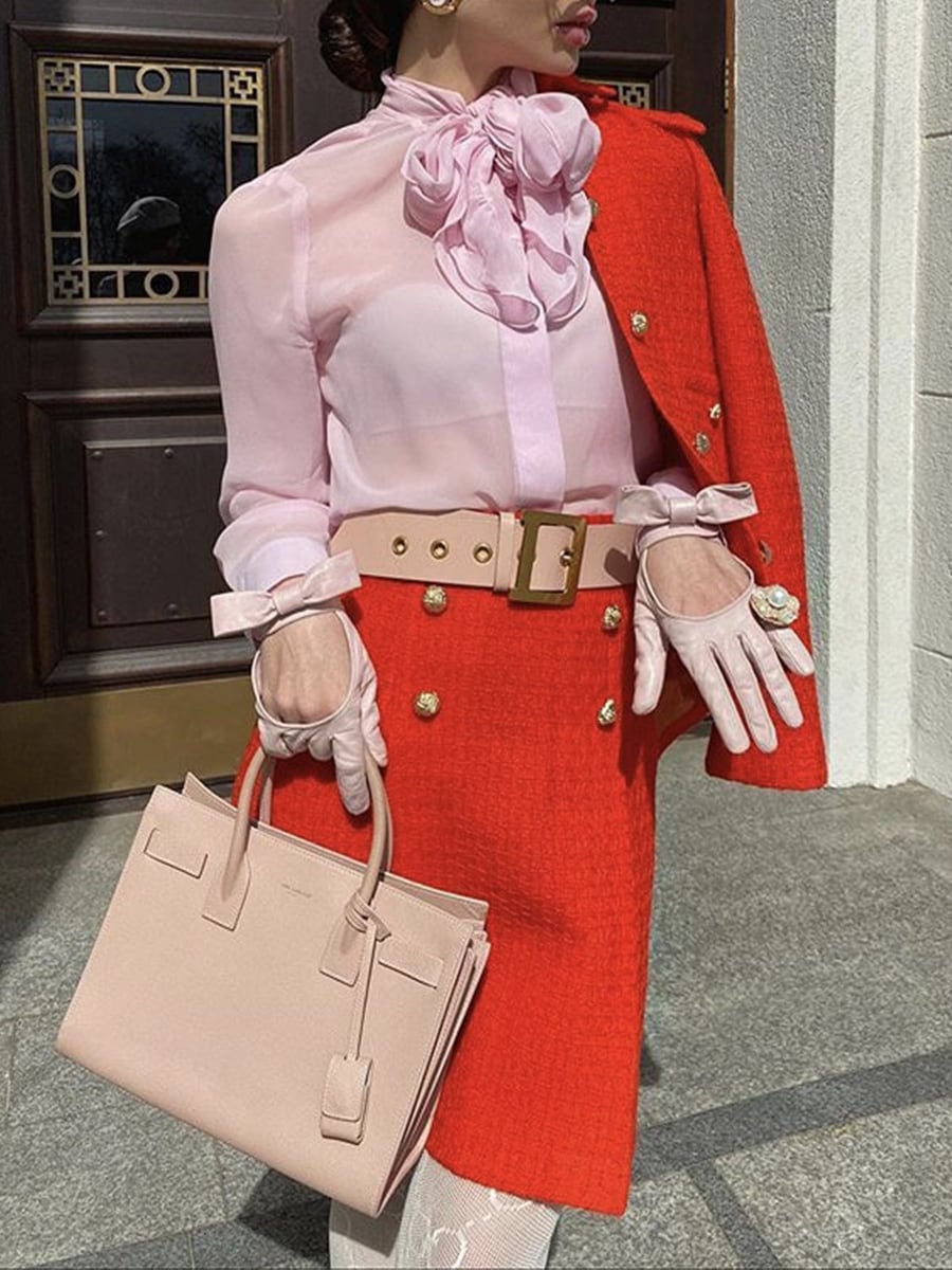 Worn over a pink blouse