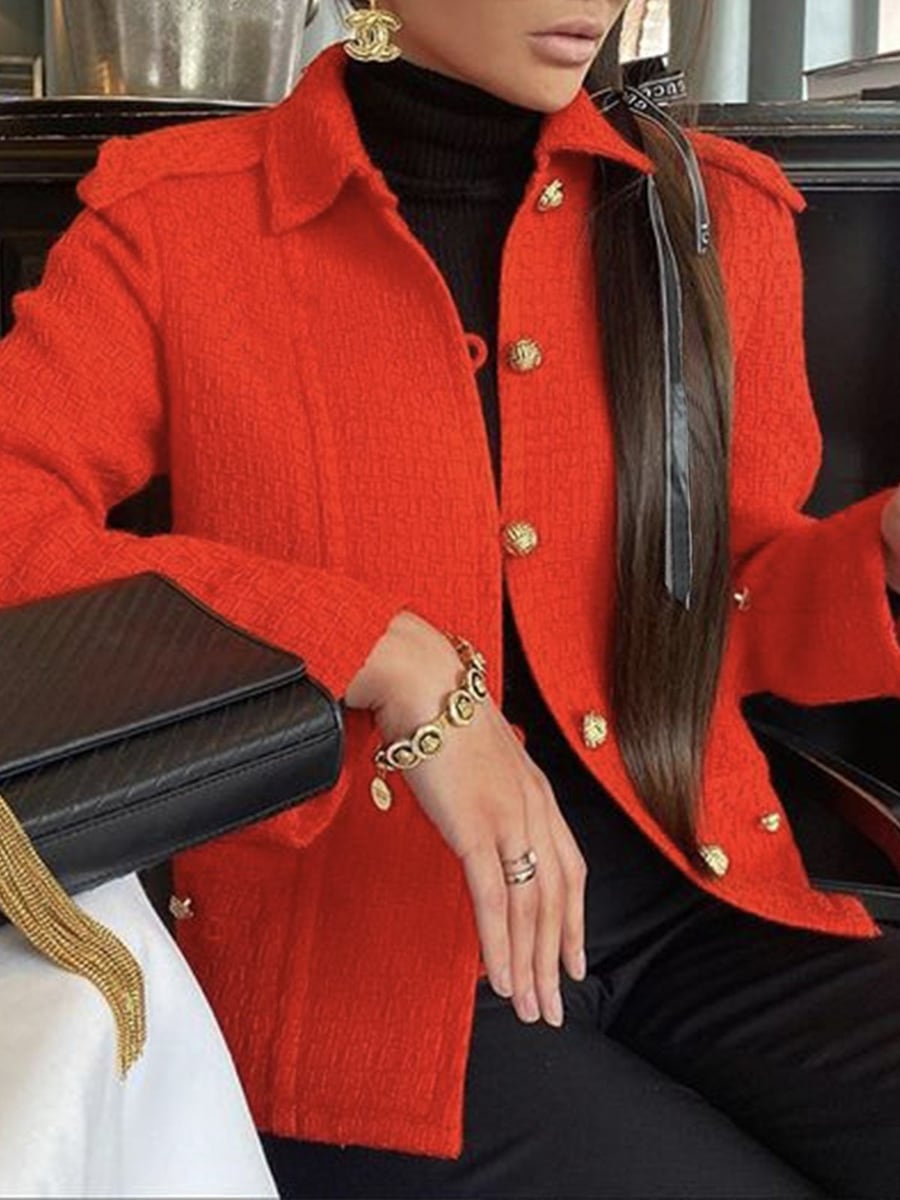 Seated, worn over a black turtleneck