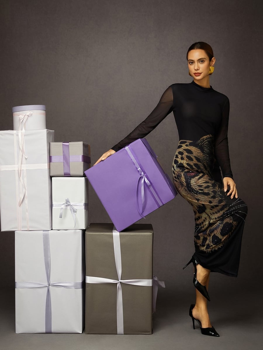 Full length, standing by gift boxes