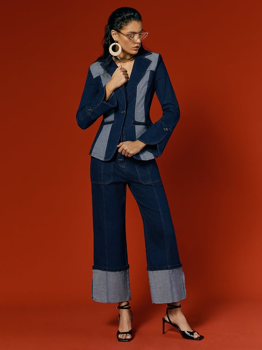 Full length, against a red backdrop